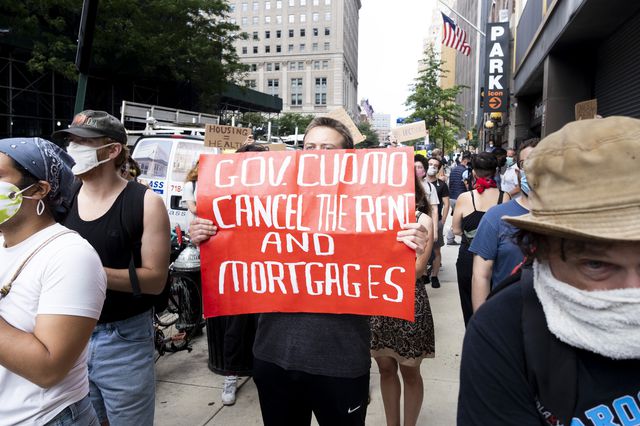 A tenant activist holds a sign that reads "Gov. Cuomo Cancel the rent and mortgages" outside of a protest in front of New York Civil Court in Brooklyn, New York on July 7.